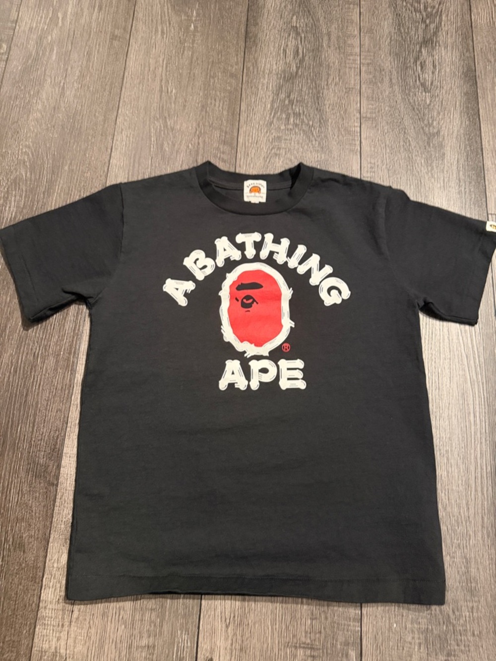 Bape Kids Black Tee with Red Ape Logo and White Lettering